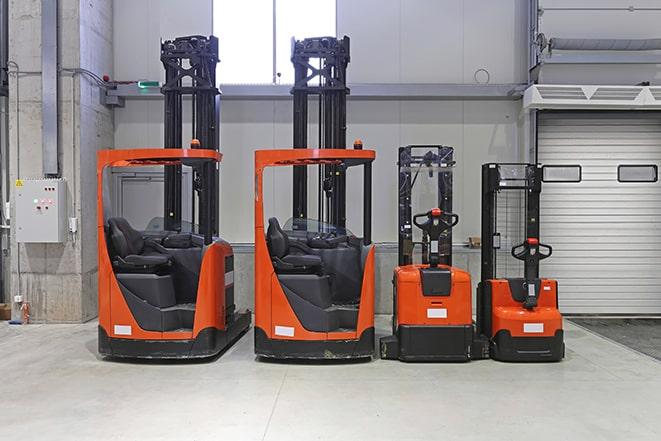 forklifts moving bags of cement at a concrete production facility